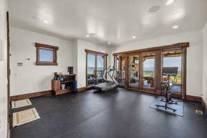 Workout area with dark rubber floors and recessed lighting