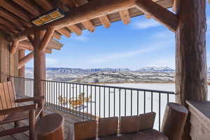 Snow covered back of property featuring a mountain view