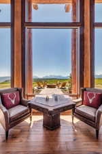 Sitting room featuring a mountain view, hardwood / wood-style floors, and healthy amount of natural light