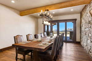 Dining area with beam ceiling, wood-type flooring, a mountain view, and recessed lighting