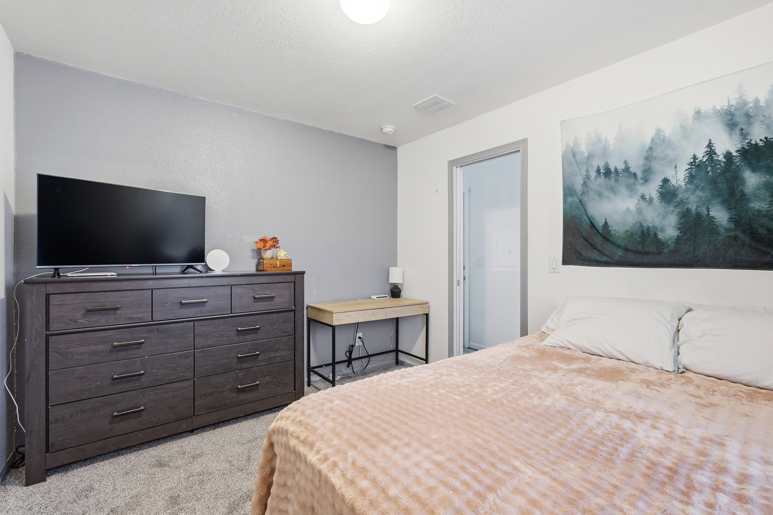 Bedroom with light colored carpet