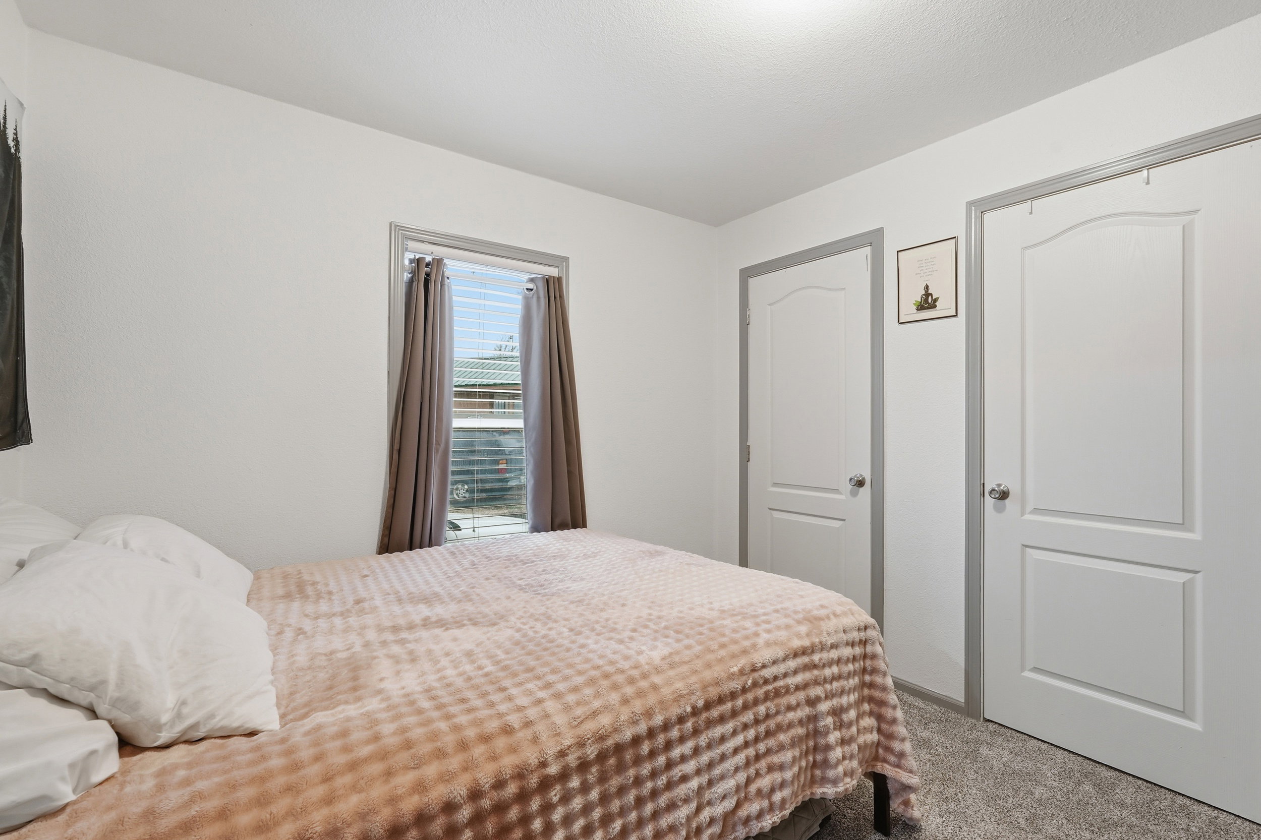 Carpeted bedroom featuring a closet