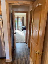 Hallway featuring dark wood-style floors