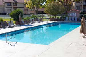 Community pool with a patio