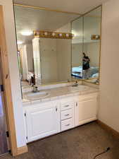 Bathroom featuring ensuite bathroom and double vanity