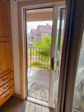 Doorway to outside with carpet