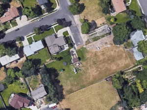 Aerial view of property's location with nearby suburban area