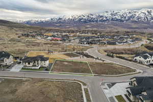 Aerial view of residential area with property boundaries highlighted and mountains