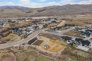 Aerial overview of property's location with nearby suburban area and mountains