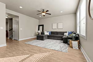Living room featuring recessed lighting, a ceiling fan, and new LVP floors