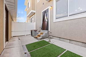 View of private back area connecting home and detached garage