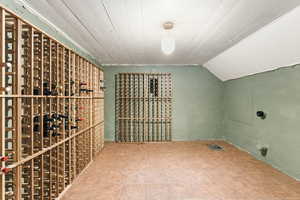 Wine area featuring a vaulted wooden ceiling and tile patterned flooring