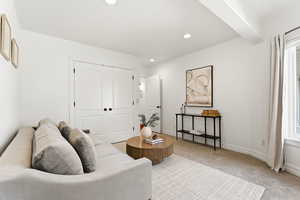 Sitting room with carpet floors, plenty of natural light, and recessed lighting