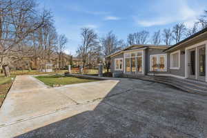 View of grassy yard featuring a patio area