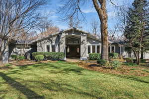 Mid-century inspired home featuring a front lawn and stucco siding