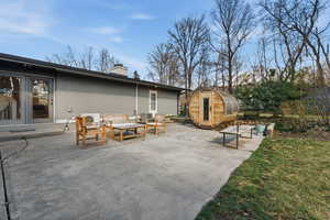View of patio with outdoor seating and an outbuilding