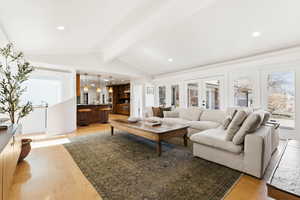 Living area featuring recessed lighting, light wood-type flooring, beamed ceiling, and french doors