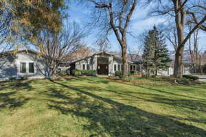 View of front of property featuring a front lawn and stucco siding