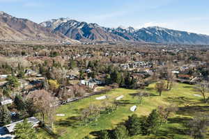 View of mountain backdrop featuring nearby suburban area and a golf course