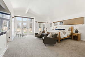 Bedroom featuring lofted ceiling, access to outside, and light carpet