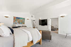 Bedroom featuring lofted ceiling with beams and carpet