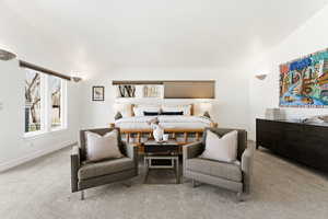 Carpeted bedroom with lofted ceiling and baseboards