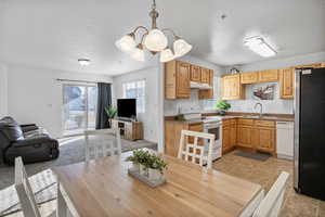 Dining space featuring a textured ceiling and suspended lighting