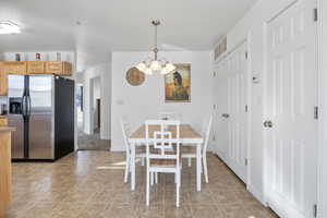 Dining space with suspended lighting and light tile patterned floors