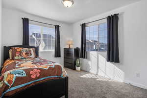 Bedroom with light carpet and baseboards
