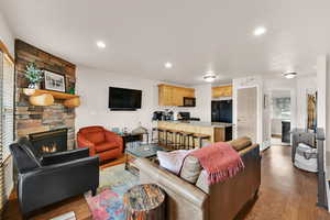 Living area with light wood-style flooring, a fireplace, and recessed lighting