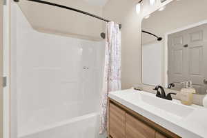Full bath featuring vanity and shower / bath combo
