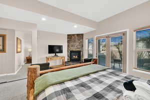 Bedroom featuring a fireplace, access to outside, recessed lighting, and light colored carpet