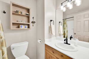 Bathroom with a shower with curtain and vanity