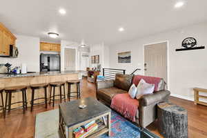 Living room featuring light wood-type flooring and recessed lighting