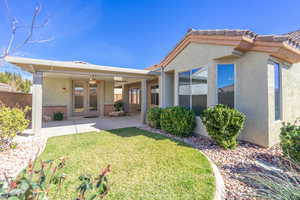 Expanded Covered Patio with ceiling fan in front of casita with french doors, stucco siding