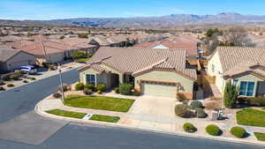 View of front facade featuring a residential view, stucco siding, a garage, and concrete driveway