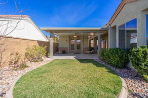 View of detached Casita  with stucco siding, a ceiling fan, french doors, and a fenced backyard