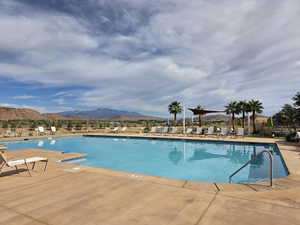 Community pool with a mountain view and a patio