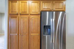 Kitchen with stainless steel refrigerator with ice dispenser