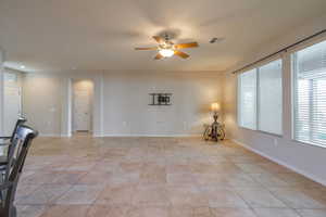 Tiled great room featuring ceiling fan and recessed lighting
