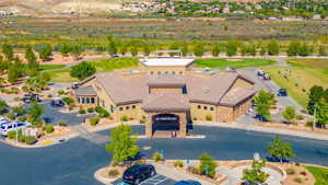 Aerial view of a local golf course with restaurant inside and a mountain backdrop