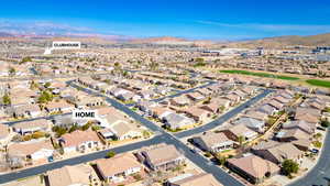 Aerial perspective of suburban area with a mountainous background