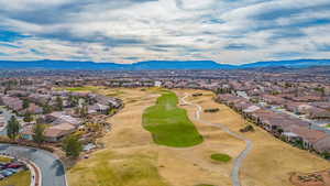 Aerial perspective of suburban area with mountains and a golf club