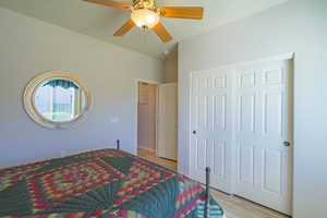 2nd Bedroom with ceiling fan, light LVP wood-type flooring, and a closet