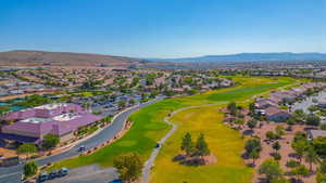 Aerial view of residential area with a golf club and a mountain backdrop