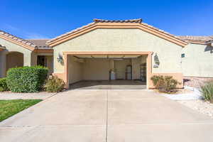 Mediterranean / spanish house featuring an attached 2.5vgarage, stucco siding, concrete driveway, and a tile roof