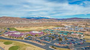 Drone / aerial view of a mountain backdrop and a golf club