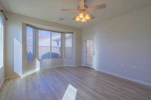 Primary bedroom with light wood-style flooring, a ceiling fan, and a door to the Patio