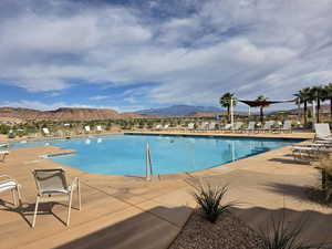 Community pool with a mountain view and a patio