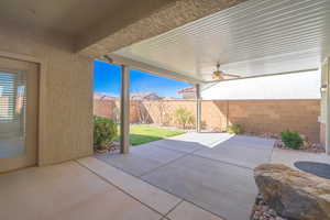 Fenced backyard featuring an expanded, patio area and a ceiling fan